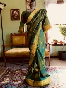 Green silk saree dress on a form outdoors